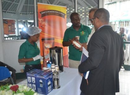 A member of Amy's Pomeroon Foods Inc explaining the details of their coffee to customers .JPG-june16