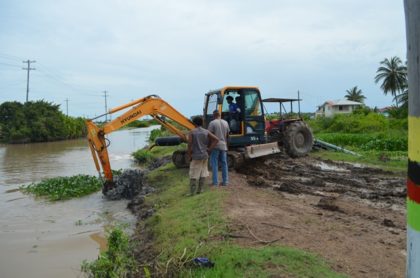 One of several excavators at work clearing the drainage canal  