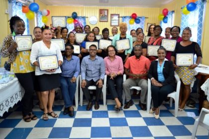 From left: Facilitator, Mr. Yohann Pooran, First Lady, Mrs. Sandra Granger, Mayor of Bartica, Mr. Gifford Marshall, Deputy Mayor, Ms. Kamal Persaud and the 26 participants of the Self Reliance and Success in Business Workshop.  