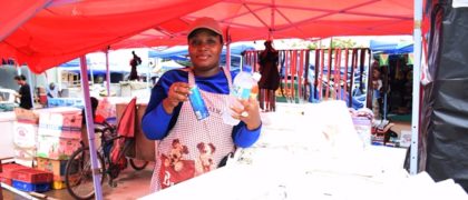 Another beneficiary of the Woman of Worth (WOW) Programme showcasing beverage on sale at her shop