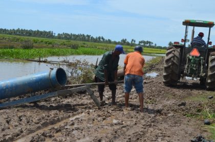 A tractor-driven pump working to assist in draining water in Region Five 
