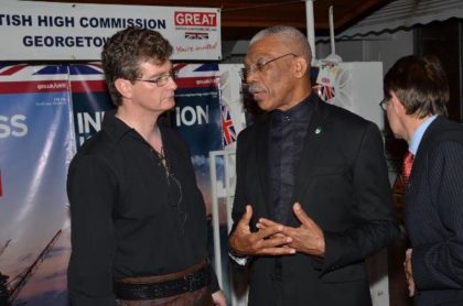 President David Granger makes a point to British High Commissioner to Guyana, Mr. Greg Quinn at the reception, which was held to mark Britain’s Queen Elizabeth’s 90th birthday.