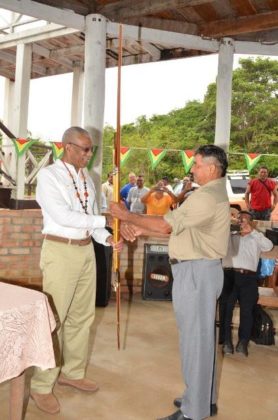 President David Granger receiving an arrow and bow, which he called a "silent missile" from Daniel Allicock of Surama Village