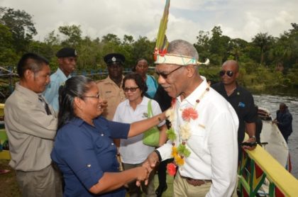 President David Granger is welcomed by Headmistress of the St. Francis Primary School, Moraikobai, Ms. Shalome Calistro, upon his arrival to the village .
