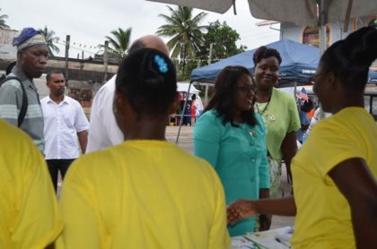 Minister in the Ministry of Public Health, Dr Karen Cummings interacting with persons at one of the booths at the health fair 