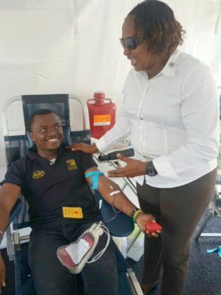 Minister within the Ministry of Public Infrastructure, Annette Ferguson (right), interacts with a member of staff during the ministry’s recent blood drive