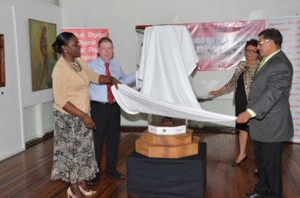 Left to right- Minister within the Ministry of Education, Nicolette Henry, CEO of Digicel, Kevin Kelly, Minister within the Ministry of Indigenous Peoples' Affairs, Valerie Garrido-Lowe and Minister of Indigenous Peoples’ Affairs, Sydney Allicock unveiling a mini totem pole, a symbol of unity