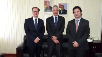 Minister of Business, Dominic Gaskin (C) with Dr. Christophe Bernasconi (L) and Ignacio Goicoechea (R)