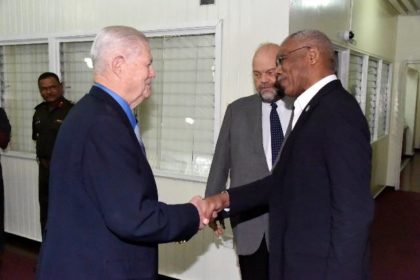 President David Granger greets Retired General Michael Carns, leader of the National Defense University's Capstone group in Guyana upon his arrival at the Ministry of the Presidency, earlier today. 