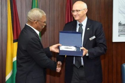 President Granger receives a token of appreciation from Colonel (Retired) Gus Greene, Director, Industrial Security Field Operations, Defense Security Service, United States of America. 