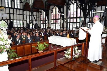 President David Granger, Prime Minister, Mr. Moses Nagamootoo and Speaker of the National Assembly, Dr. Barton Scotland are seated in the front pew at the funeral service for the late Bishop Randolph George