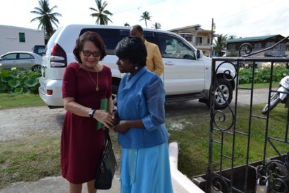 Pastor Victorine Kellman of the Tabernacle Moravian Church greets First Lady, Mrs. Sandra Granger on her arrival at the church for the opening service of the Third International Moravian Women’s Conference.