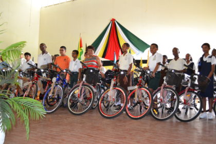 Minister of Social Cohesion, Ms. Amna Ally and some of the Demerara-Mahaica recipients of bicycles and backpacks, this morning, in the Queen’s College auditorium
