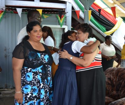Minister of Social Cohesion, Ms. Amna Ally receives a warm welcome from a student at the presentation exercise hosted in the compound of the Department of Education, East Berbice-Corentyne