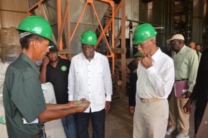 Assistant Farm Manager, Mr. Christopher Moses showing President David Granger and Barbados Prime Minister Freundel Stuart the quality of rice produced at the Santa Fe rice mill 