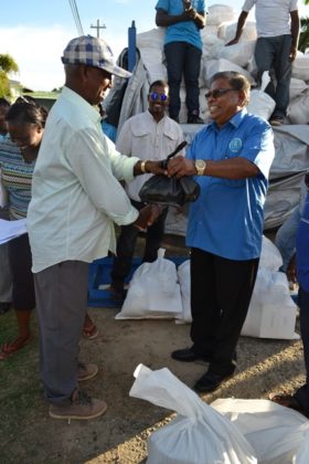  Mr. Rajkumar Suhkra and CDC Chairman Colonel (ret’d) Chabilall Ramsarup share a light joke as he collects his hamper at the Union/Naarstigheid Neighbourhood Democratic Council at Bush Lot. 