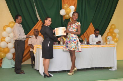 Ms. Adeti DeJesus, of the Office of the Presidential Advisor on Youth Empowerment presents a certificate to Akeila Dey