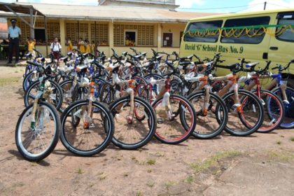 Twenty-five bicycles and the ‘David G School Bus No. 9’ in the compound of the Mahdia community centre