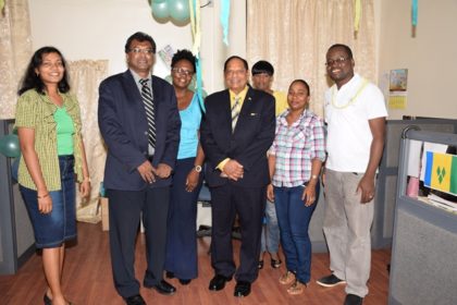 Prime Minister Nagamootoo and Minister of Public Security pose with staff at the St. Vincent exhibit during the CARICOM Culture Day activity, at the Ministry of Public Security.