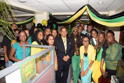 Prime Minister Nagamootoo and Minister of Public Security pose with staff at the Jamaica exhibit during yesterday’s CARICOM Culture Day activity, at the Ministry of Public Security.