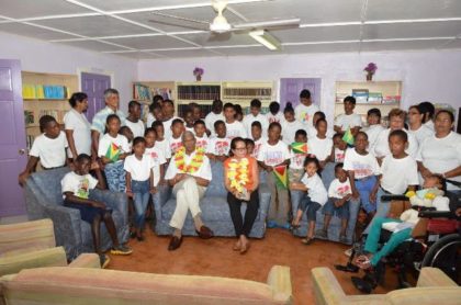  President David Granger and First Lady, Mrs. Sandra Granger with the children, director and care-givers in the library in the Hope Children’s Home