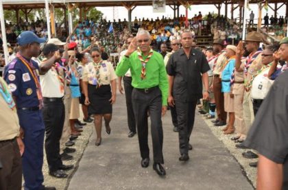 President Granger acknowledges the salute by the Scouts of the 14 participating countries, as they welcome him to the opening ceremony of the 14th Caribbean Cuboree, which is being held in Guyana. 