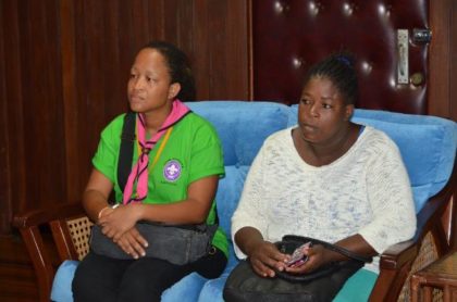 Mothers of the two injured Cub Scouts (left) Ms. Jacqueline Matthew and (right) Ms. Delia Finistere listen intently to President David Granger, during the meeting this morning.