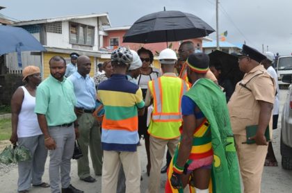(Centre) Minister within the Ministry of Public Infrastructure, Annette Ferguson listening to the concerns of Sophia residents