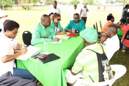 Minister within the Ministry of Natural Resources, Simona Broomes interacting with residents of the public at the outreach in Linden 