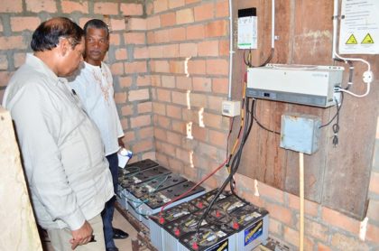 Prime Minister Moses Nagamootoo and Radio Paiwomak Coordinator Virgil Harding inspecting the batteries donated by OPM.