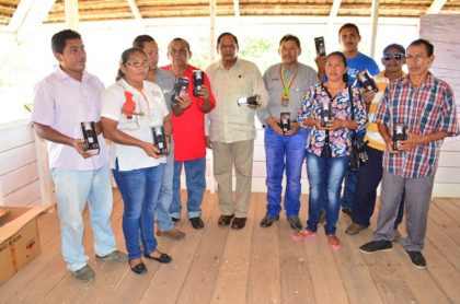 Prime Minister Moses Nagamootoo and Vice President Sydney Allicock NRDDB executives and village representatives who were presented with solar LED lights.