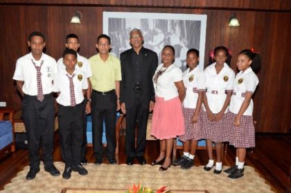 President David Granger is flanked by Ms. Carol Monroe (right) and Mr. Bruce Monroe (left) and students of the Phoenix Elementary School,  during their visit to the Ministry of the Presidency earlier today. 