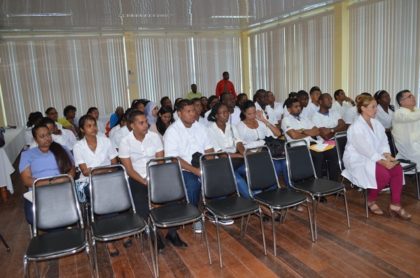 Cuban Trained sixth year medical students being debriefed by Permanent Secretary of the Department of Public Service, Reginald Brotherson during the orientation session.