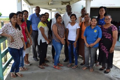 Presidential Advisor on eGovernment and Chief Executive Officer of the eGovernment Agency, Mr. Floyd Levi (back, centre) and some of the teachers of Skeldon Line Path Secondary School, including Head Mistress, Ms. Jenny O’Brien (first, right) and Mr. Phillip Walcott, (blue-checked shirt)  Director of the connectivity aspect of the project.