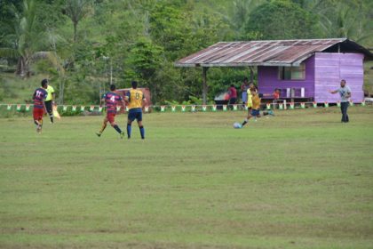 Kamarang and Waramadong football teams in action during the opening fixture of the football competition, which is the main event of the Upper Mazaruni 19th Annual District Games in Kamarang, Cuyuni Mazaruni