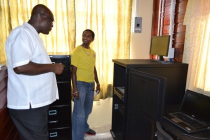 Mr. Roopesh Persaud, of the Upper Corentyne Industrial Training Centre, gives Presidential Advisor on eGovernment and Chief Executive Officer of the eGovernment Agency, Mr. Floyd Levi a closer look at the server that facilitates connectivity at the centre.