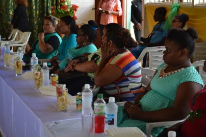 These participants pay keen attention to First Lady, Mrs. Sandra Granger as she delivers her address. 