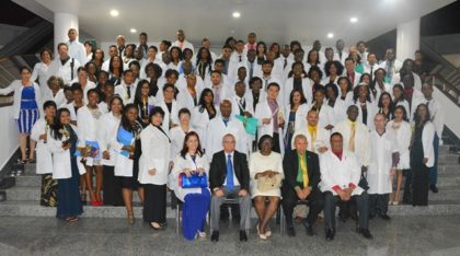 Minister of Public Health, Dr. George Norton, Minister within the Ministry of Public Health, Dr. Karen Cummings and Cuban Ambassador to Guyana, Mr. Julio César González Marchante pose with the 86 graduates as well and teachers of the 2016 Guyana/Cuba Medical Scholarship Programme