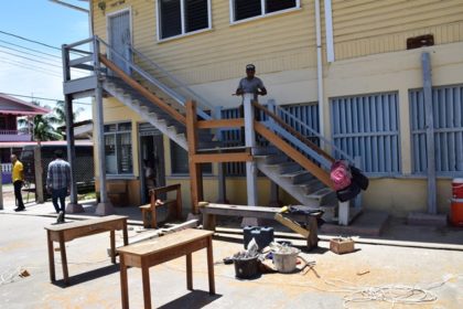 Workers renovating the stairway of the Lower Corentyne Secondary school 