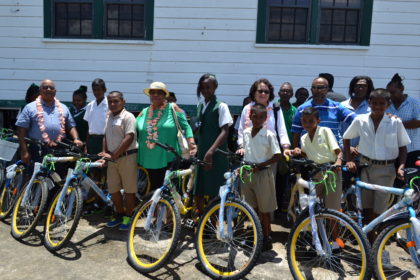 Recipients of the bicycles donated by the Guyana Bahamas Association pose with (L-R)  Regional Executive Officer, Mr. Dennis Jaikarran, Minister of Social Cohesion, Ms. Amna Ally, First Lady, Mrs. Sandra Granger and President of the Association Mr. Deavindra Jagroo