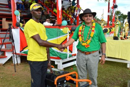 Minister of Indigenous Peoples Affairs, Mr. Sydney Allicock hands over a generator to President of the District Sports Council, Mr. Rudolph Wellington.