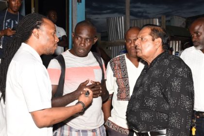 Prime Minister Moses Nagamootoo, and Regional Members of Parliament, Jermaine Figueira and Audwin Rutherford in discussion with a resident during the walkabout 