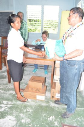 Minister of Indigenous Peoples’ Affairs, Sydney Allicock presenting medical supplies to Assakata, Region One, Toshao, Sharon Aloysious