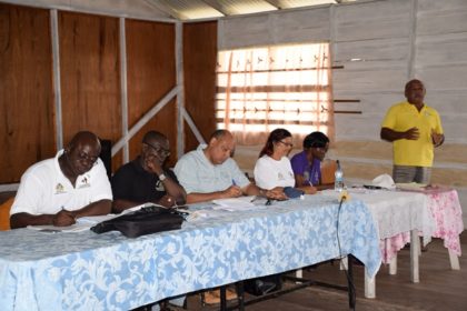 Minister of Natural Resources, Raphael Trotman and team including Permanent Secretary of the Ministry of Communities, Emilie McGarrel at the meeting in Imbaimadai, Region Seven