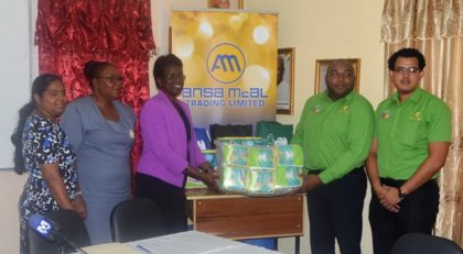 Ansa McAl representatives hand over diapers to Ministry of Education representatives. From left to right; Head of School Health, Nutrition and HIV/AIDS unit Janelle Sweatnam, Deputy Chief Education Officer, Donna Chapman, Permanent Secretary of the Ministry of Education, Delma Nedd along with Ansa Mcal representatives. 