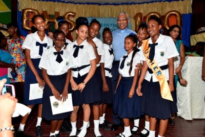 President David Granger poses with some of the current students of the Berbice High School at the school's centenary celebrations, earlier today.