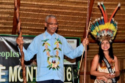President Granger shows off his gifts, which were presented by the Indigenous people