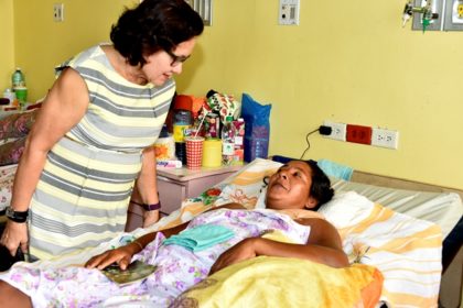 First Lady, Mrs. Sandra Granger comforts Ms. Ophelia James during a visit with her, this morning, at the Georgetown Public Hospital Corporation.
