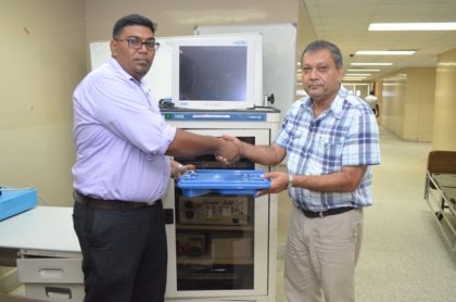 Surgeon and Senior Surgical Registrar, Dr. Ravi Motilall hands over endoscopic equipment to Chief Executive Officer (CEO) of the Georgetown Public Hospital Corporation, Michael Khan