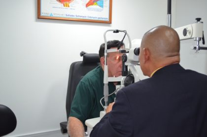 Minister of Public Health, Dr. George Norton performs an Ophthalmology examination on Dr. Philip Da Silva 